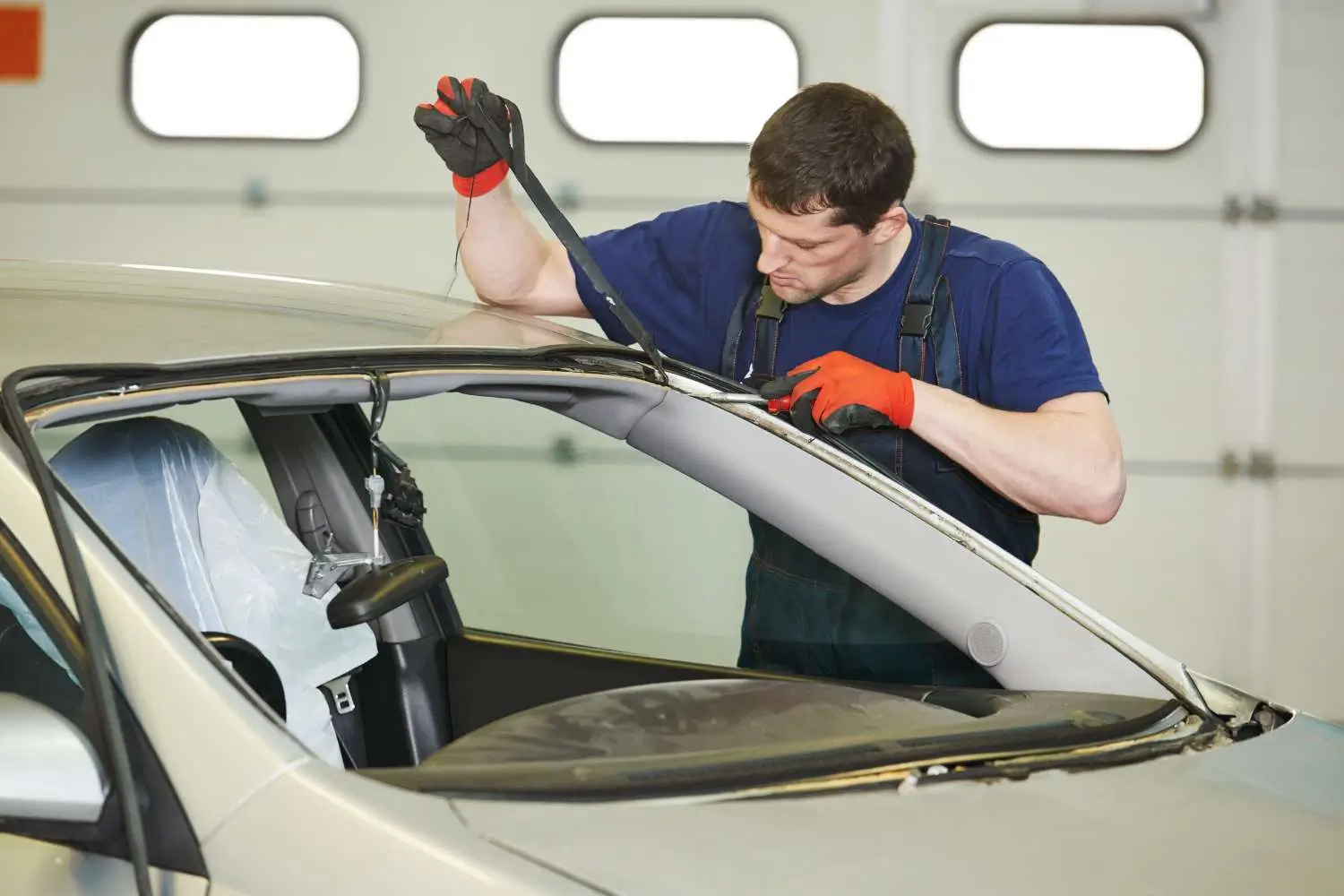 Young man preparing for a windscreen repair