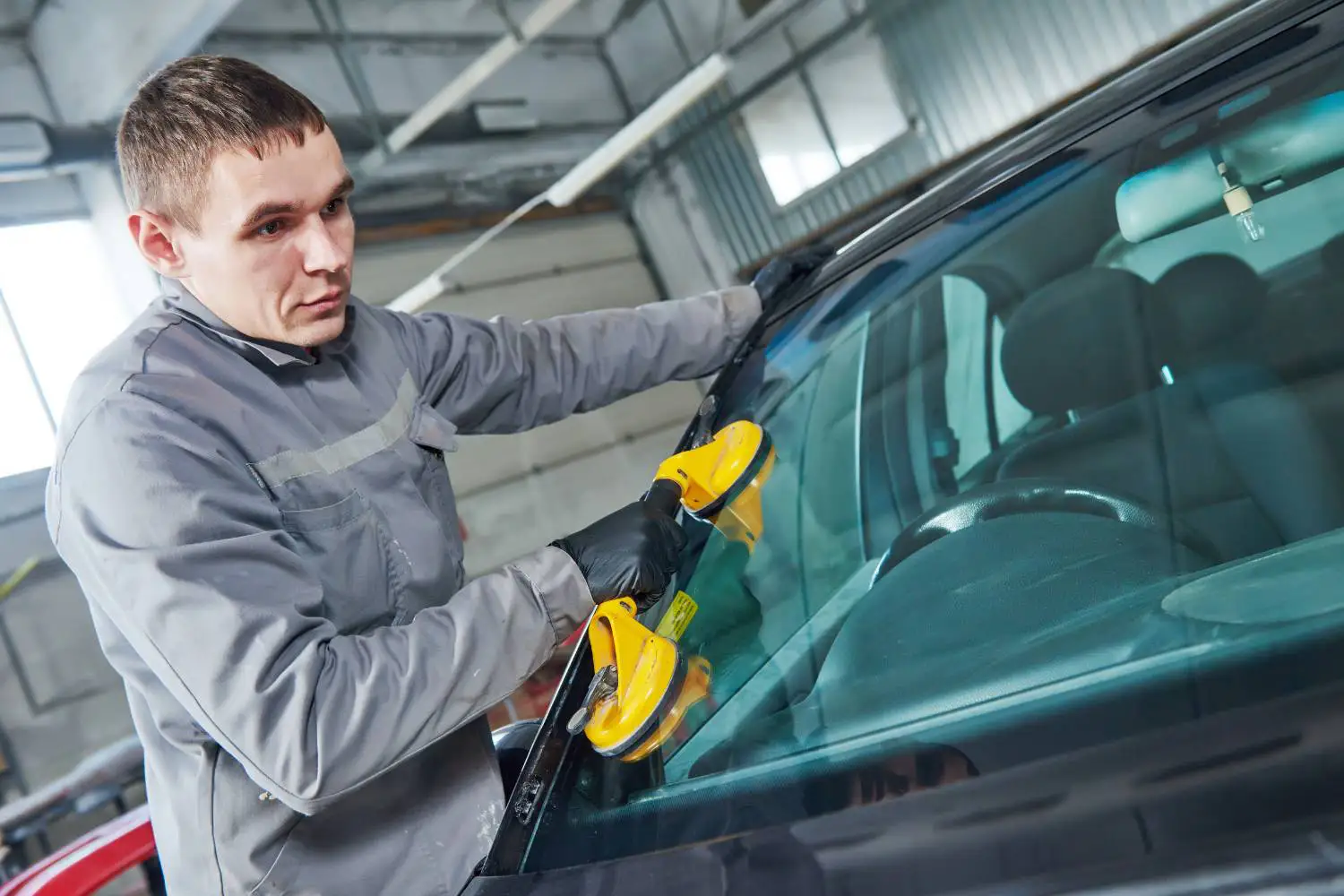 Reliable windscreen replacement technician positioning a new windscreen